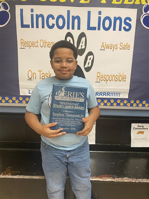 Stephen Thompson, Jr., Lincoln's November Stairclimber, poses with his plaque.